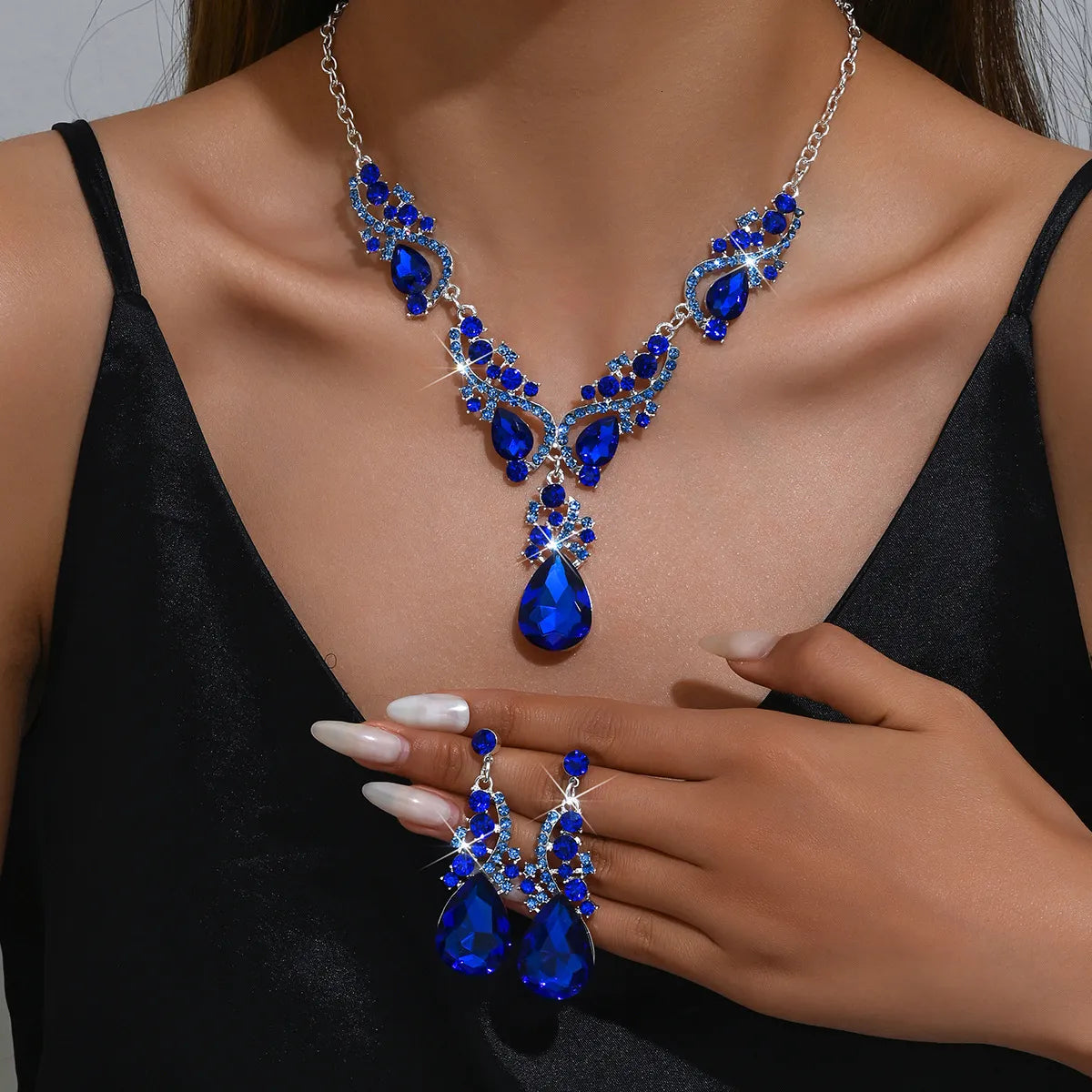 Women’s blue crystal jewelry set with a teardrop pendant and matching earrings, elegant style for weddings and formal occasions