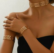 GNIT 4-Piece Jewelry Set Consisting Of A Gold Fashion Hollowed Out Collar, A Gold Fashion Hollowed Out Arm Bracelet, A Gold Fashion Hollowed Out Bracelet, And A Gold Fashion Hollowed Out Ring, Suitable For Women's Daily Wear. It Is A High-End Jewelry Euro