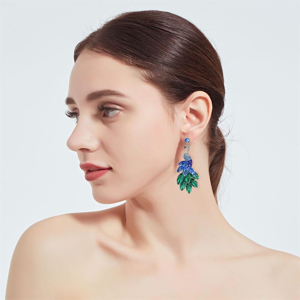 Elegant peacock-inspired dangle earrings featuring green crystal feather accents.