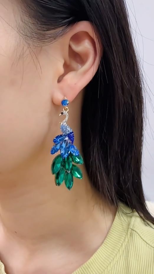 Elegant peacock-inspired dangle earrings featuring green crystal feather accents.