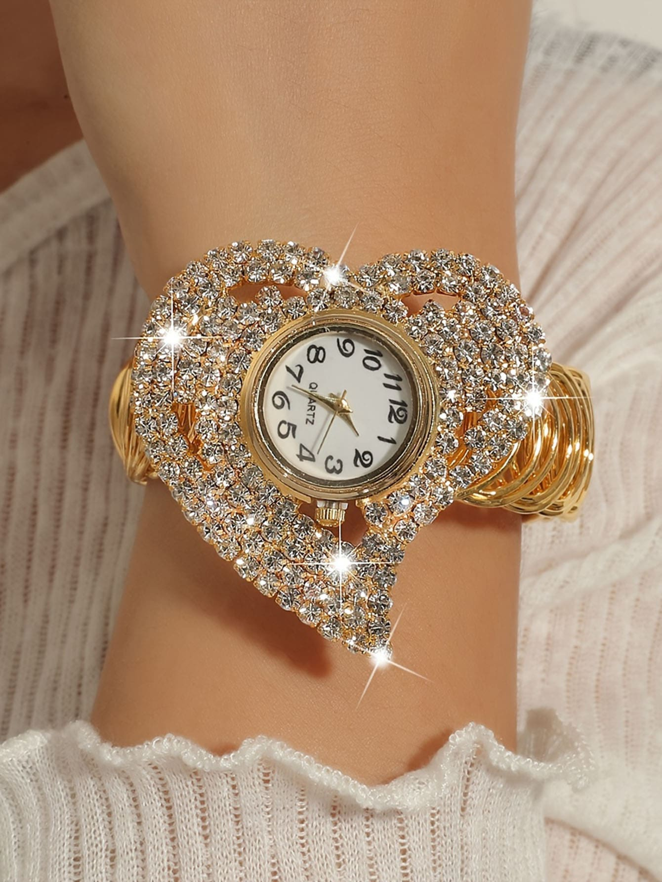 Women's gold diamond wristwatch, luxury brand design with rhinestone bracelet.
