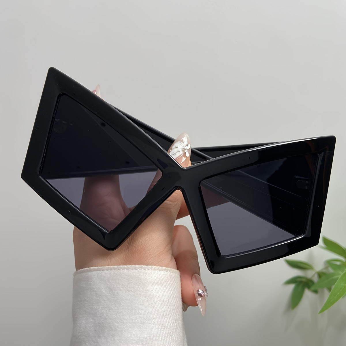 Black oversized futuristic sunglasses with sharp geometric frames – a bold statement accessory that adds drama and edge to any outfit.